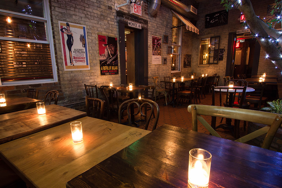 Candlelit tables and theater posters in the Atrium